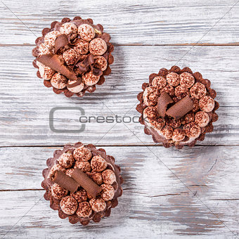 chocolate cupcakes on an old wood table, view from above, close-