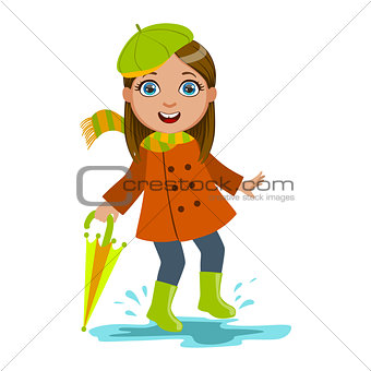 Girl In Green Beret With Umbrella, Kid In Autumn Clothes In Fall Season Enjoyingn Rain And Rainy Weather, Splashes And Puddles