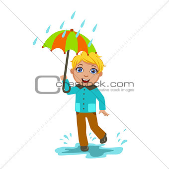 Boy Under Raindrops With Umbrella , Kid In Autumn Clothes In Fall Season Enjoyingn Rain And Rainy Weather, Splashes And Puddles