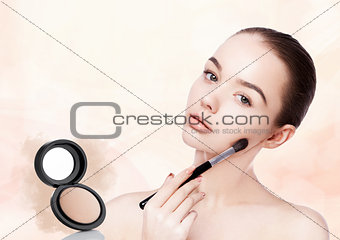 Beautiful girl holding makeup brush for foundation