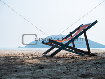 Deck chair on sandy beach