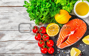 portion of fresh salmon steak with aromatic herbs, close-up
