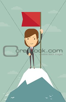 Woman with flag on a Mountain peak