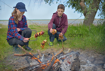 Teenagers enjoying barbecue outdoors 