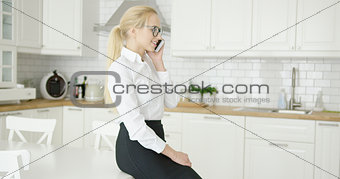 Confident young woman talking by phone