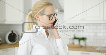 Pretty young female talking by phone