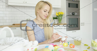 Young girl coloring eggs for holiday