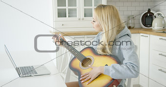 Woman playing electric guitar