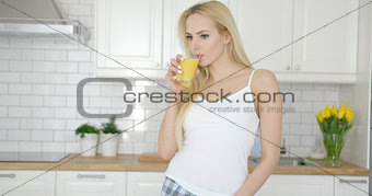 Slim girl drinking orange juice