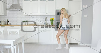 Funny girl dancing in kitchen