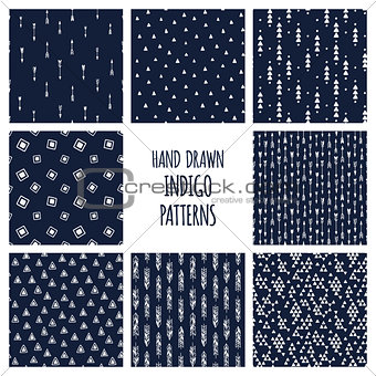 Dark blue indigo set of patterns. Hand drawn vector triblal backgrounds with triangles and arrows.
