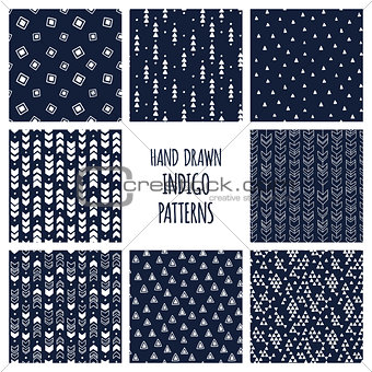 Set of hand drawn indigo blue and white patterns. Seamless vector triblal aztec backgrounds with triangles and arrows.