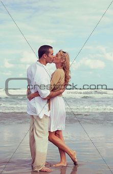 Romantic Man and Woman Couple Kissing On A Beach