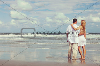 Romantic Man and Woman Couple Embracing On A Beach