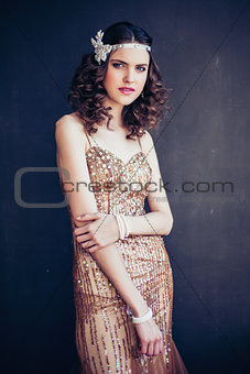 Fashion photo of beautiful girl wearing sparkling evening dress.