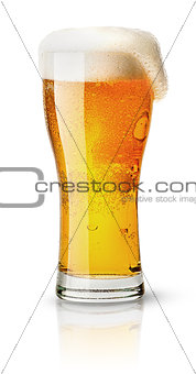 Light beer in sweaty glass and foam