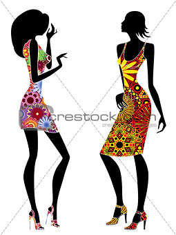 Slender stylish young women in short ornate dresses