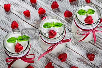 yogurt with raspberries and mint, selective focus