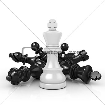 White king standing over fallen black chess pieces