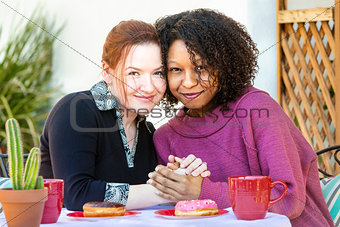 Female couple sitting at table together
