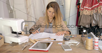 Young woman working with sketches