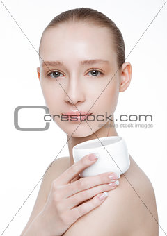 Beauty girl holding face body cream container