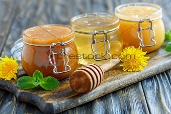 Buckwheat, linden and flower honey in glass jars.