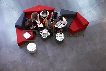 Overhead Shot Of Businesswomen Meeting In Lobby Of Office