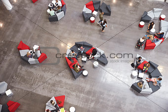 Students groups sitting in a modern university atrium
