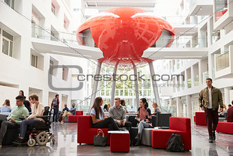 Groups of students meet in the lobby of their university