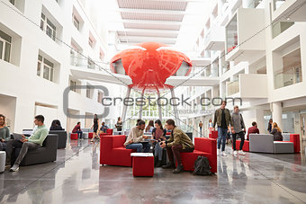 Students socialising in the lobby of modern university