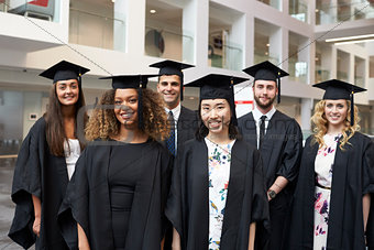 Group portrait of university graduates in cap and gown