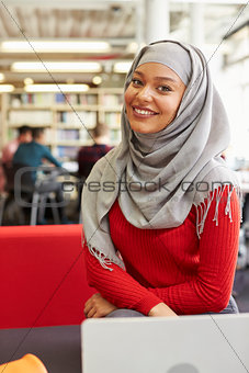 Portrait Of Female University Student Working In Library