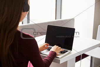 View Over The Shoulder Of Female Student Using Laptop