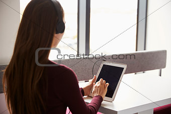 View Over The Shoulder Of Female Student With Digital Tablet