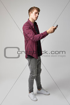 Studio Portrait Of Male Journalist With Digital Recorder