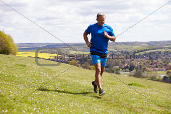 Mature Man Jogging In Countryside