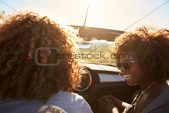 Couple in an open top car, rear passenger point of view