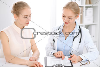Doctor and  patient  sitting at the desk