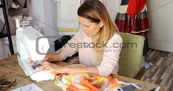 Female sewing with machine