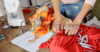 Crop seamstress choosing fabric for dress