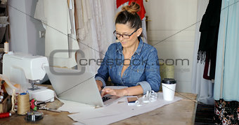 Female with laptop in parlour