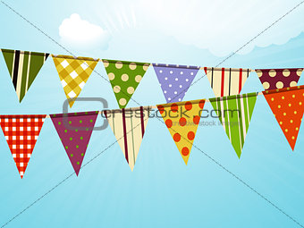 Vintage colorful bunting over sky background