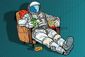 Astronaut the audience with beer and popcorn sitting in a chair