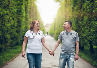 Happy loving couple on a romantic walk outdoors in park
