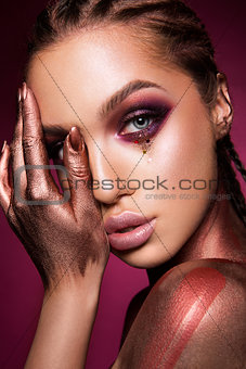 Portrait of beautiful woman with sparkles on her face.