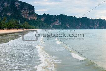 Thai wooden boat on the waves in the bay of Krabi resort, Thaila