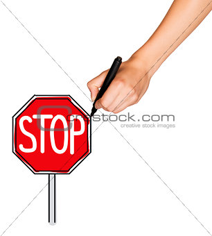 A female hand holds marker and draws stop sign