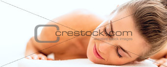 Relaxed young woman on massage table
