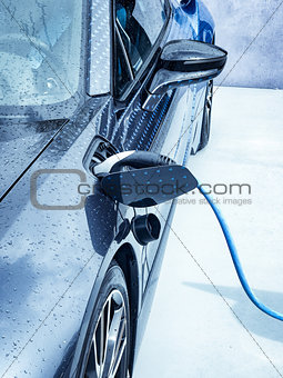 Electric vehicle being plugged in